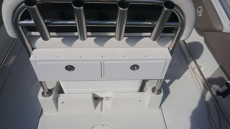 Slide: The Image of 2023 Finseeker 210 FC boat interior with rod holders and storage compartments. - 19