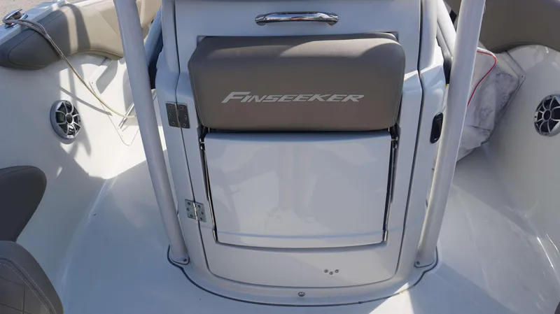 Slide: The Image of 2023 Finseeker 210 FC boat interior with seating and storage compartment. - 7