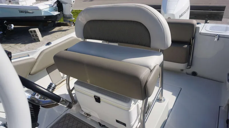 Slide: The Image of 2023 Finseeker 210 FC boat interior with cushioned seating and steering wheel. - 9