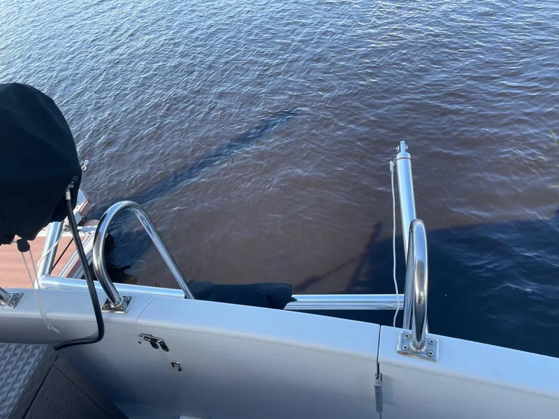 Slide: The Image of Marine Trader 1987 40 LaBelle Sun Deck boat with water view and railing. - 24