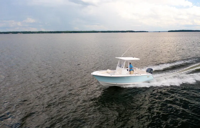 Slide: The Image of 2025 Sea Hunt Ultra 229 boat cruising on open water. - 10