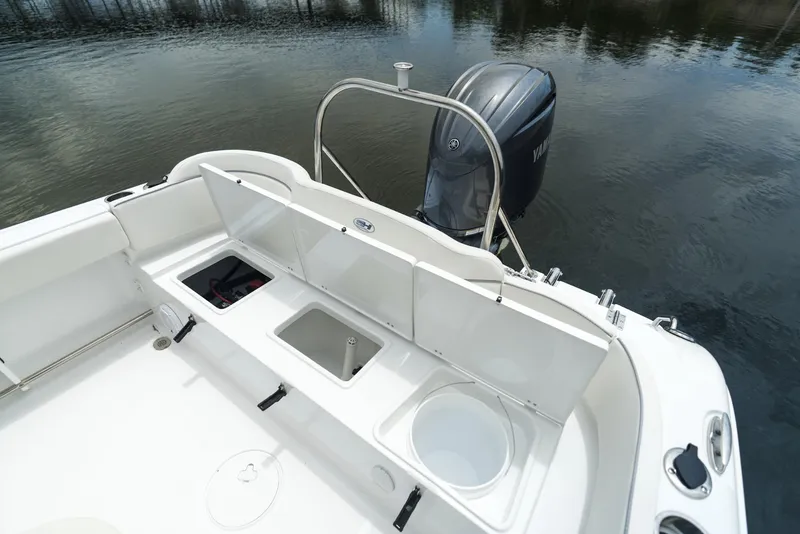 Slide: The Image of 2025 Sea Hunt Ultra 229 boat with Yamaha outboard engine on calm water. - 13