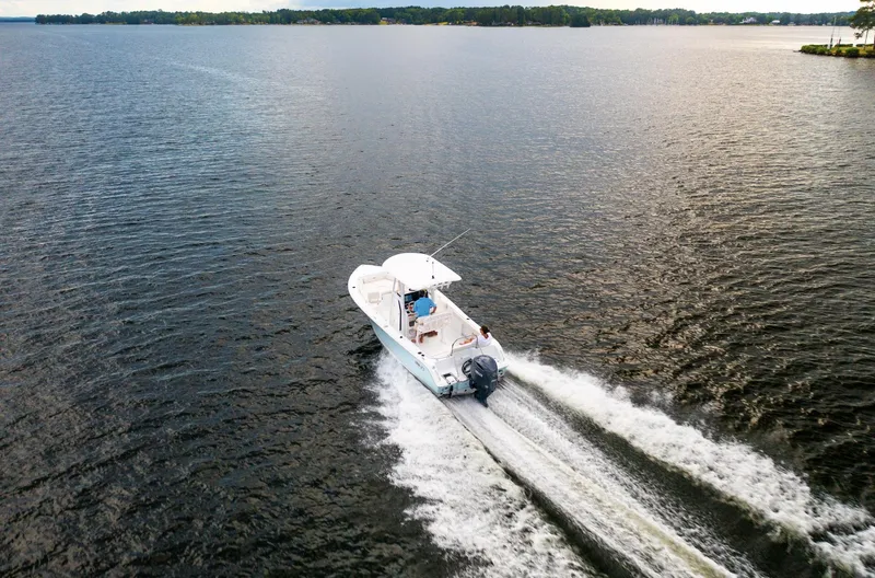 Slide: The Image of 2025 Sea Hunt Ultra 229 boat cruising on open water. - 19