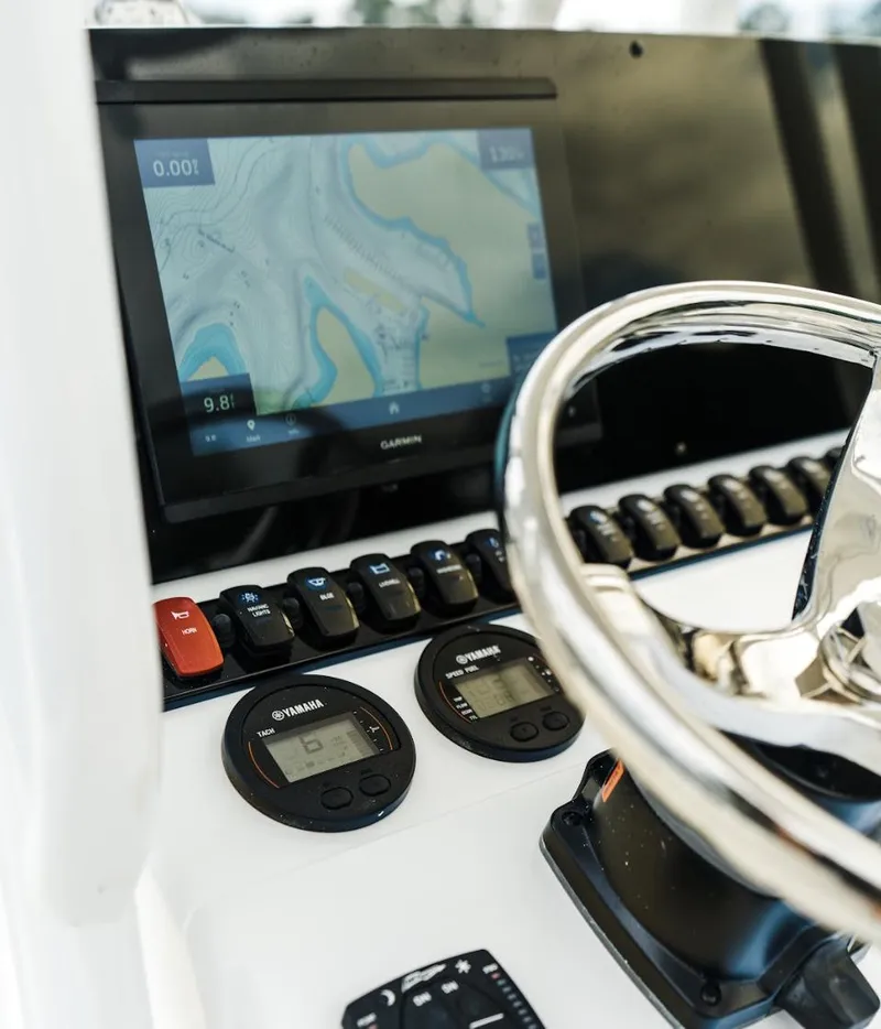 Slide: The Image of 2025 Sea Hunt Ultra 229 dashboard with navigation screen and controls. - 3