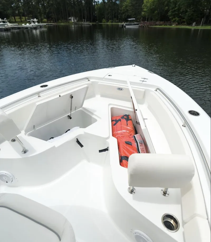Slide: The Image of 2025 Sea Hunt Ultra 229 boat interior with storage compartments and life jackets. - 4