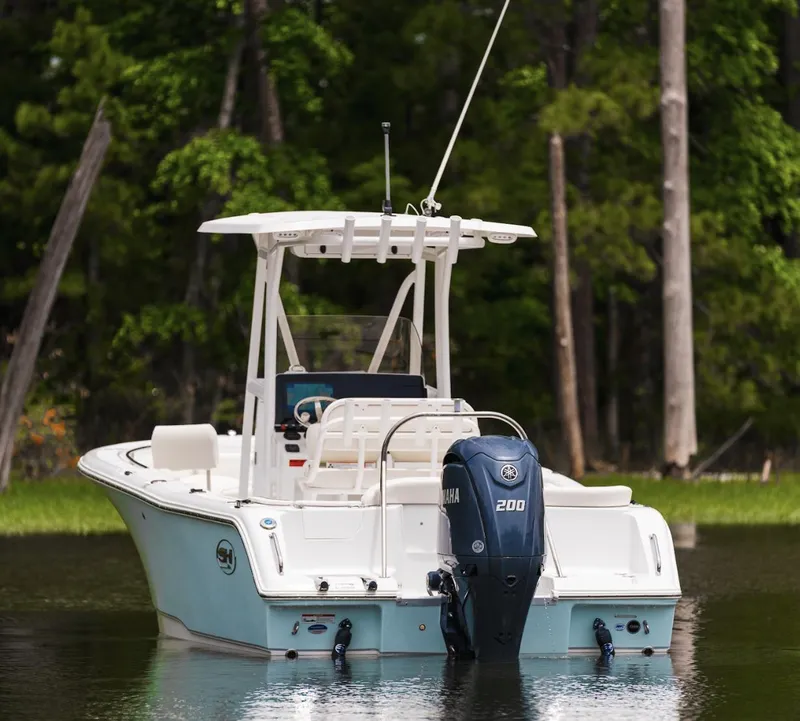 Slide: The Image of 2025 Sea Hunt Ultra 229 boat with Yamaha 200 engine on a calm lake. - 6