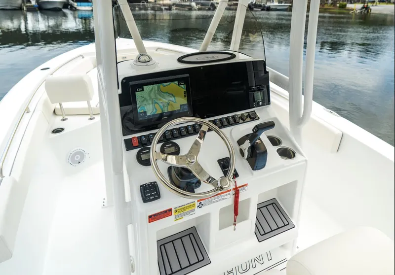 Slide: The Image of 2025 Sea Hunt Ultra 229 boat dashboard with navigation system and steering wheel. - 8