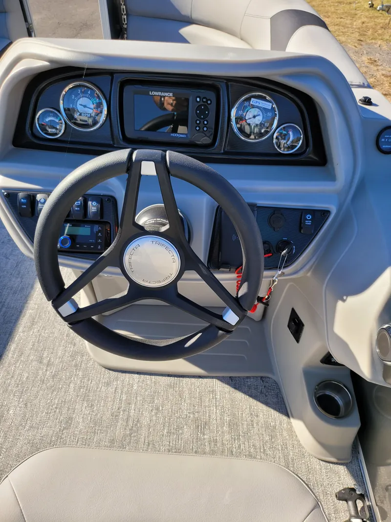 Slide: The Image of 2025 Trifecta 22TRFCLE boat dashboard with steering wheel and control panel. - 14