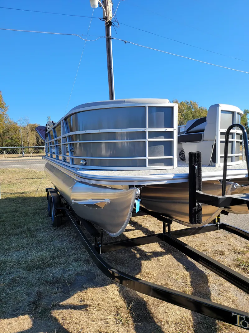 Slide: The Image of 2025 Trifecta 22TRFCLE pontoon boat on trailer, parked on grass. - 5