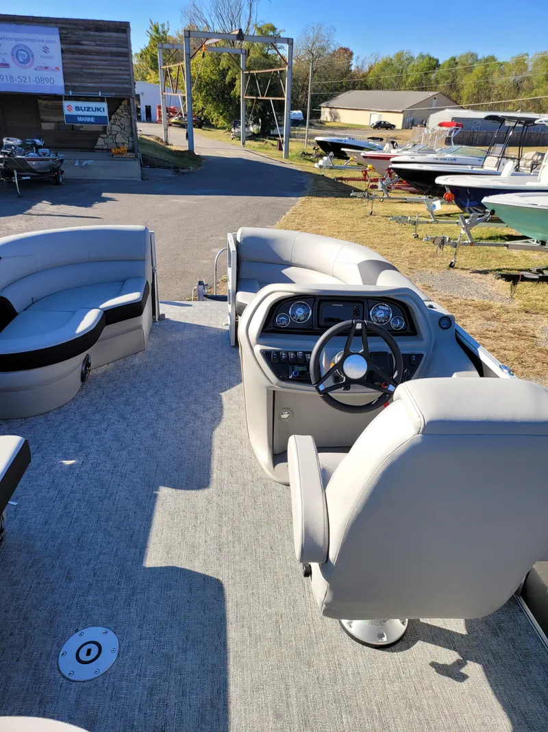 Slide: The Image of 2025 Trifecta 22TRFCLE pontoon boat interior with steering console and seating. - 6