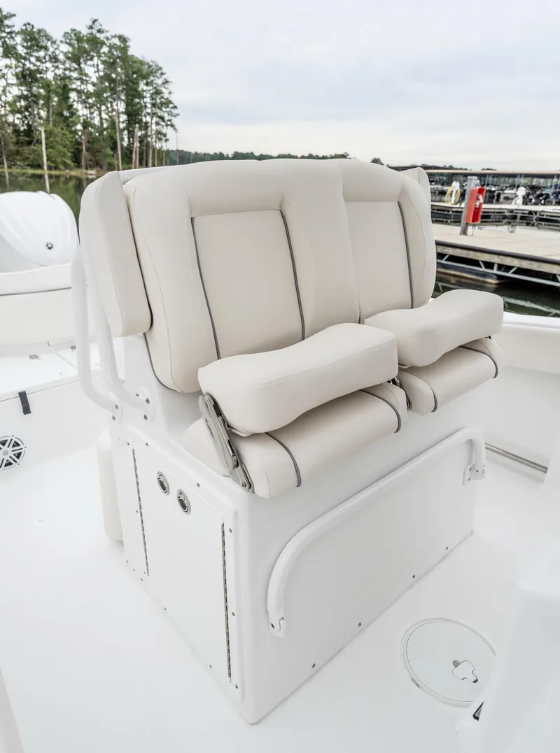 Slide: The Image of 2025 Sea Hunt Ultra 245 SE boat seating, featuring plush, white cushioned seats. - 10