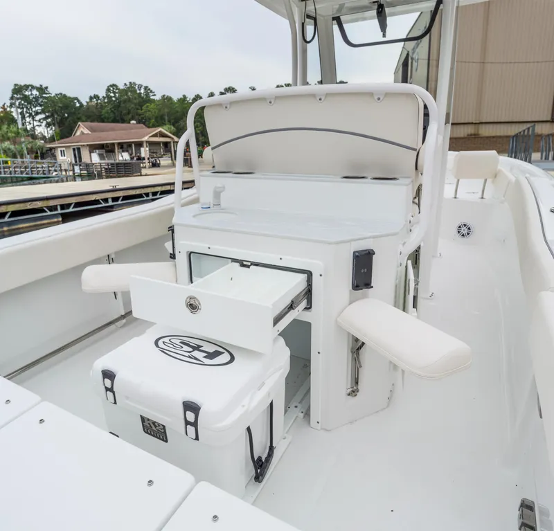Slide: The Image of 2025 Sea Hunt Ultra 245 SE boat interior with storage and seating. - 12