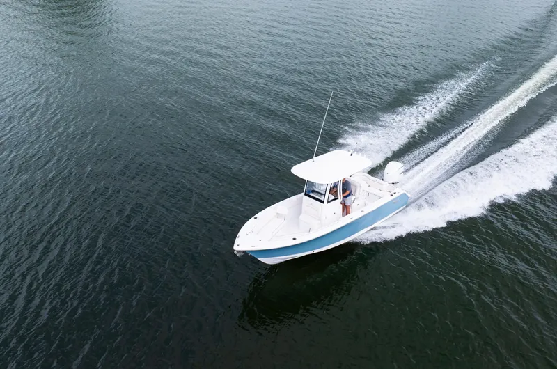 Slide: The Image of 2025 Sea Hunt Ultra 245 SE boat cruising on open water. - 13