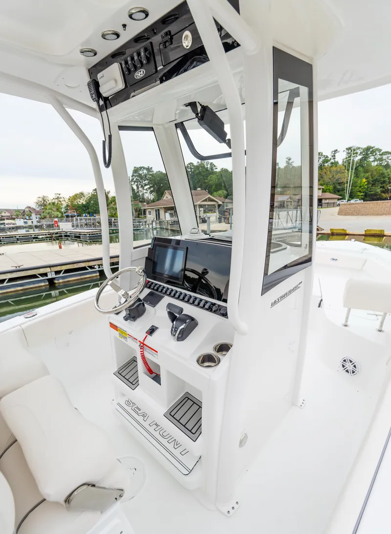 Slide: The Image of 2025 Sea Hunt Ultra 245 SE boat console with modern controls and seating. - 17