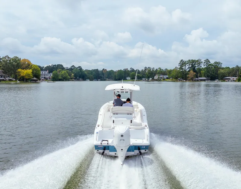 Slide: The Image of 2025 Sea Hunt Ultra 245 SE cruising on a serene lake. - 18