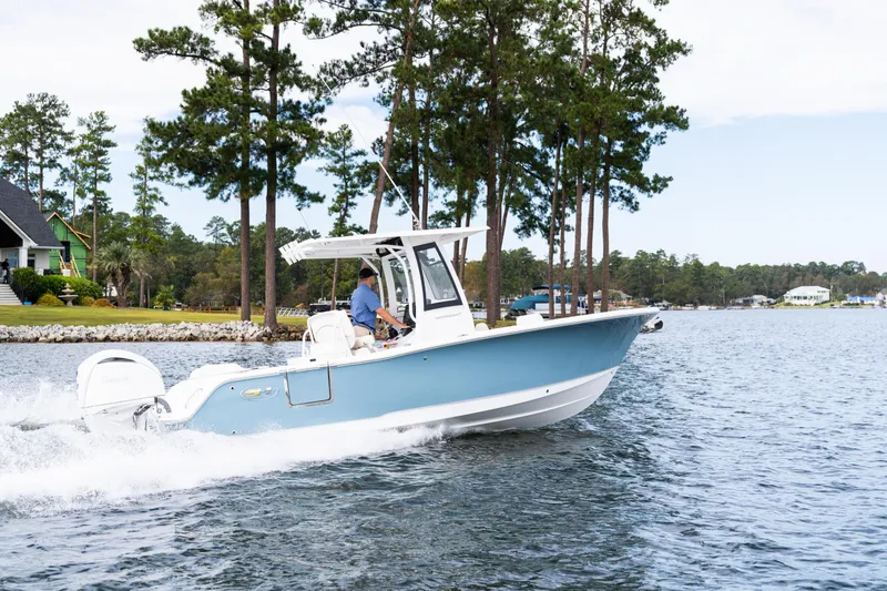 Slide: The Image of 2025 Sea Hunt Ultra 245 SE boat cruising on a scenic lake. - 4