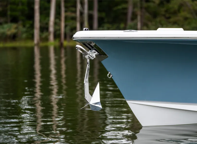 Slide: The Image of 2025 Sea Hunt Ultra 245 SE boat with anchor on calm water. - 6