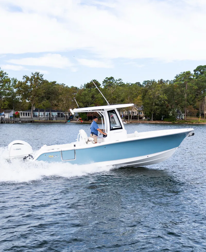 Slide: The Image of 2025 Sea Hunt Ultra 245 SE boat cruising on a lake. - 7
