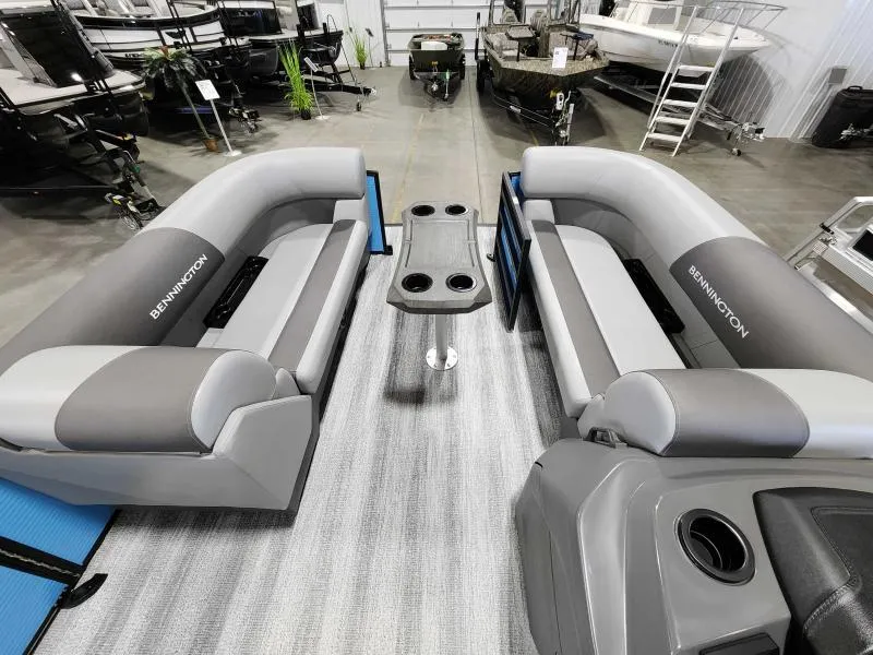 Slide: The Image of 2025 Bennington 20SSR pontoon boat interior with gray seating and central table. - 3