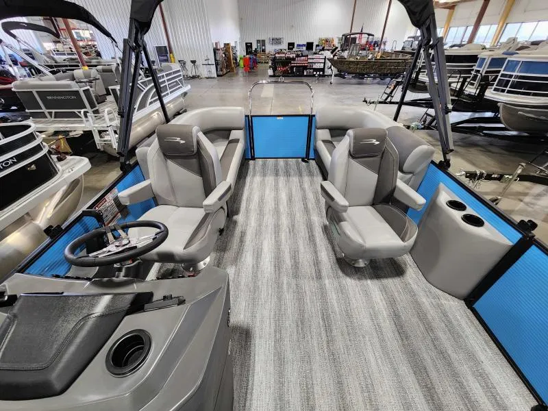 Slide: The Image of 2025 Bennington 20SSR pontoon boat interior with modern seating and steering console. - 4