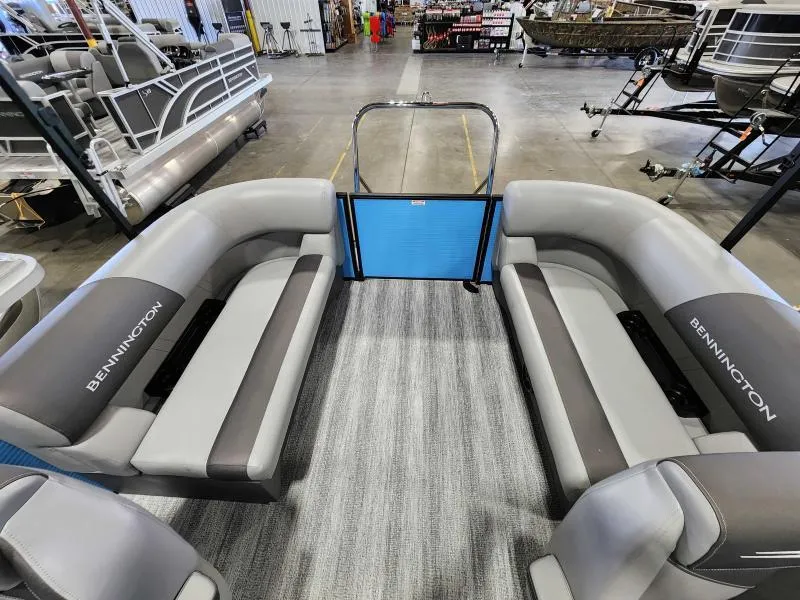 Slide: The Image of 2025 Bennington 20SSR pontoon boat interior with gray seating in showroom. - 6
