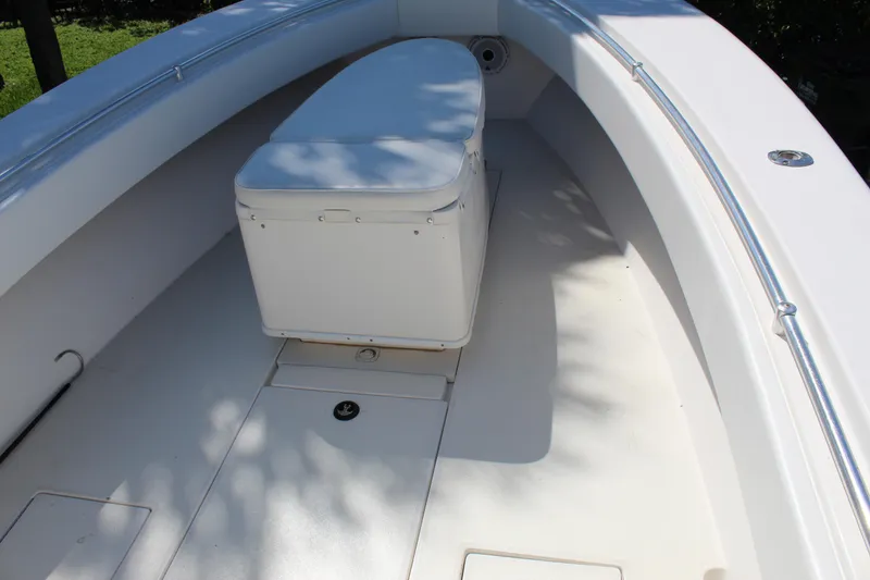 Slide: The Image of 2002 Contender 31 CC boat interior with cushioned seating and clean deck. - 13