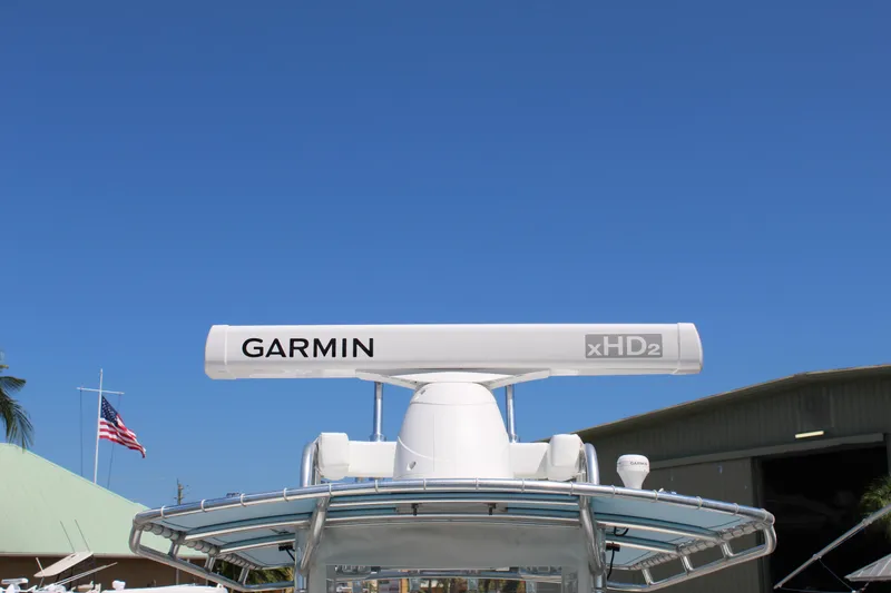 Slide: The Image of Contender 31 CC 2002 boat with Garmin xHD2 radar against clear blue sky. - 15