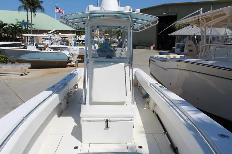 Slide: The Image of 2002 Contender 31 CC boat at a marina, showcasing center console and spacious deck. - 16