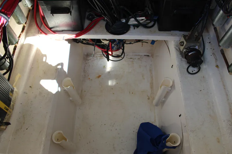 Slide: The Image of 2002 Contender 31 CC boat interior wiring and storage compartment. - 23