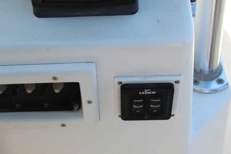 Slide: The Image of Close-up of 2002 Contender 31 CC boat controls with Lenco trim tab switches. - 26