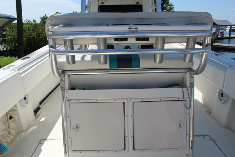 Slide: The Image of 2002 Contender 31 CC boat interior with rod holders and storage compartments. - 27