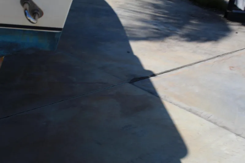 Slide: The Image of Shadow of a 2002 Contender 31 CC boat on concrete pavement. - 29