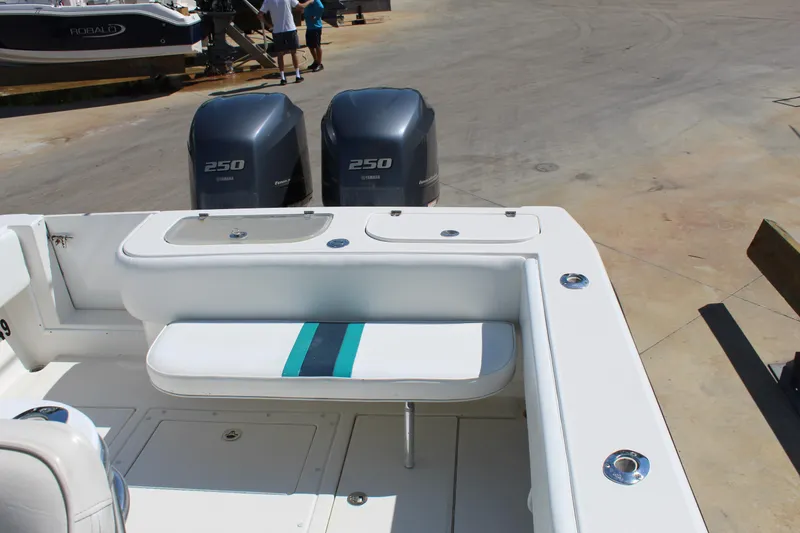 Slide: The Image of 2002 Contender 31 CC boat with twin 250 engines, featuring a white and teal seat. - 5
