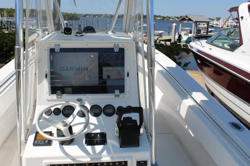 Slide: The Image of 2002 Contender 31 CC boat dashboard with Garmin navigation system, docked at marina. - 30
