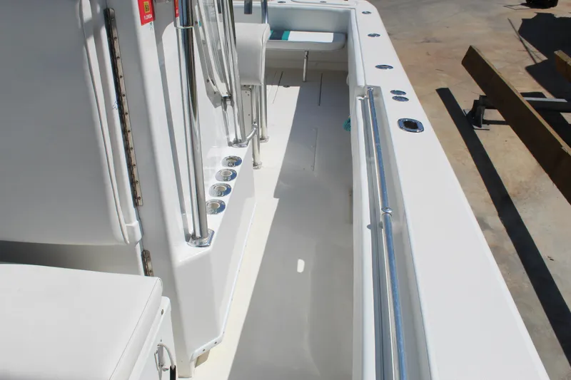 Slide: The Image of 2002 Contender 31 CC boat interior with rod holders and seating area. - 27