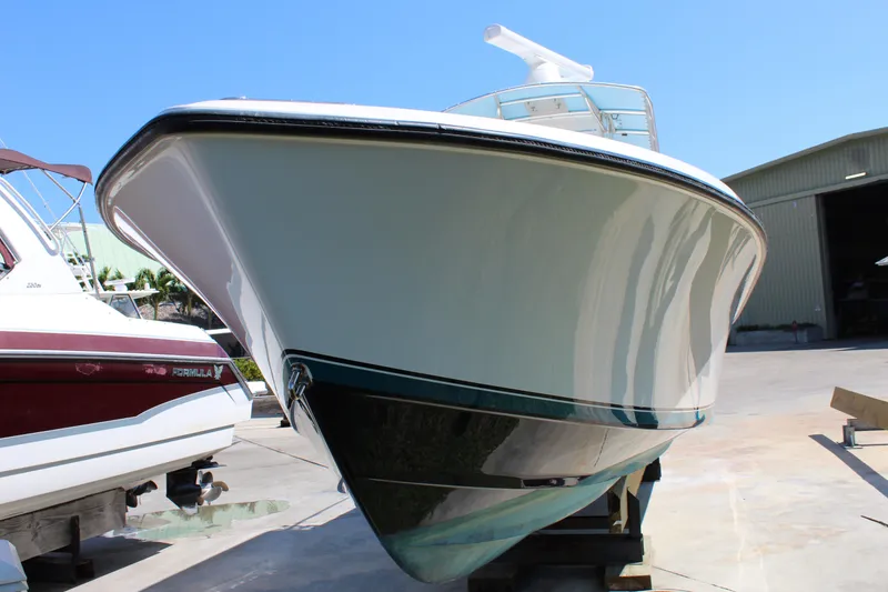 Slide: The Image of 2002 Contender 31 CC boat on dry dock, showcasing sleek hull design. - 37