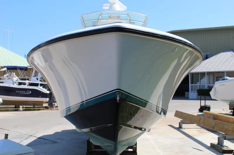 Slide: The Image of 2002 Contender 31 CC boat on display at a marina, front view. - 35