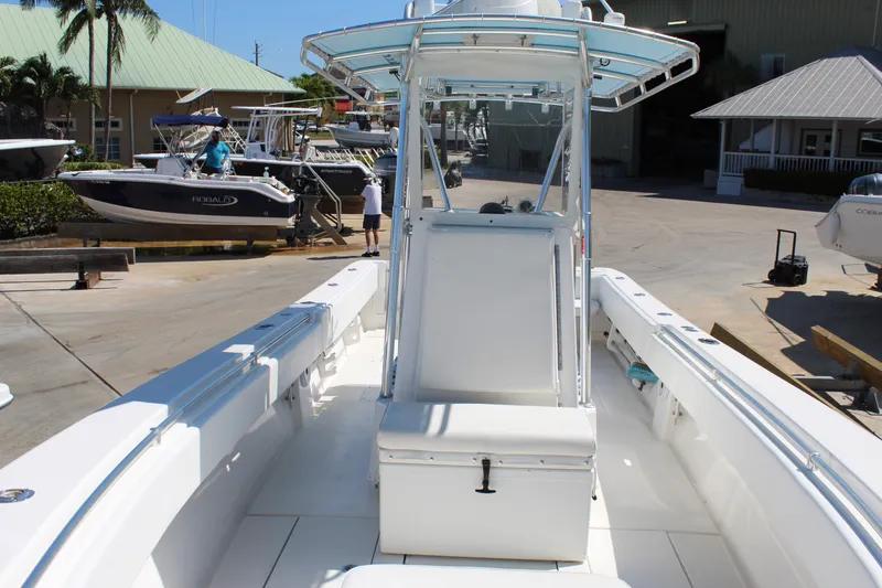 Slide: The Image of 2002 Contender 31 CC boat with center console and seating, docked at a marina. - 22