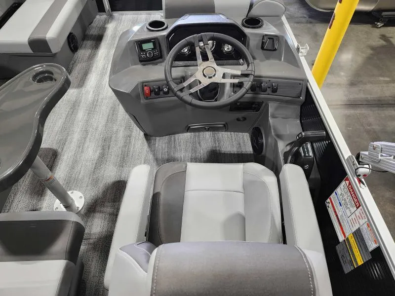 Slide: The Image of 2025 Bennington 168SLJ boat interior with steering wheel and seating. - 2