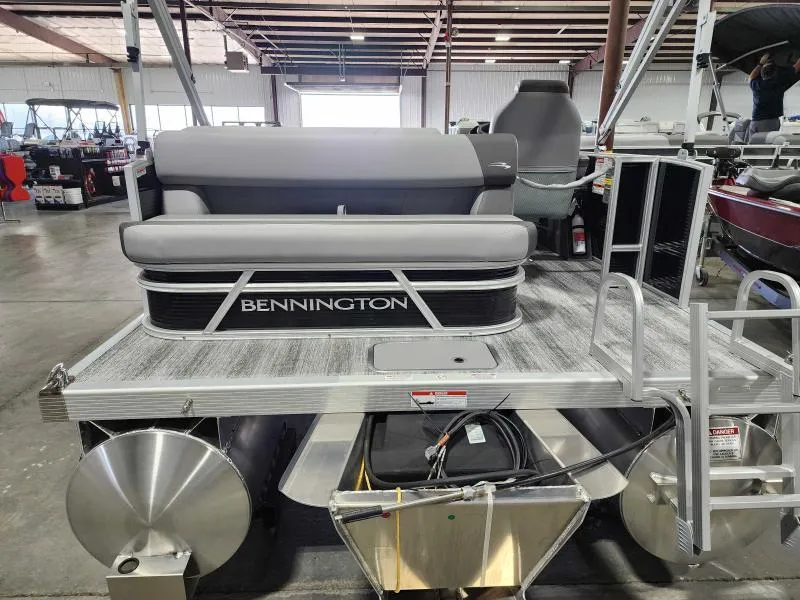Slide: The Image of 2025 Bennington 168SLJ pontoon boat in a showroom, featuring sleek seating and modern design. - 3