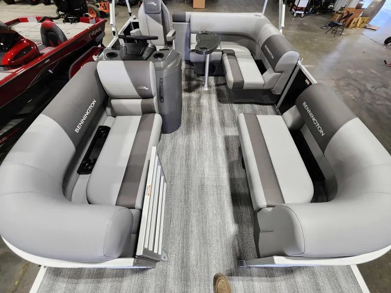 Slide: The Image of 2025 Bennington 168SLJ pontoon boat interior with gray seating and carpeted floor. - 4