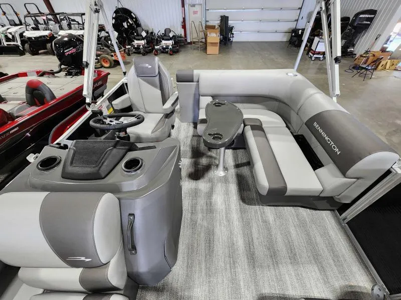 Slide: The Image of 2025 Bennington 168SLJ pontoon boat interior with gray seating and steering console. - 6