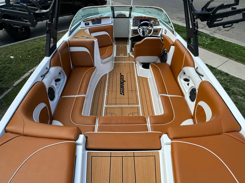 Slide: The Image of 2025 Sanger 231SL boat interior with brown leather seats and modern dashboard. - 12