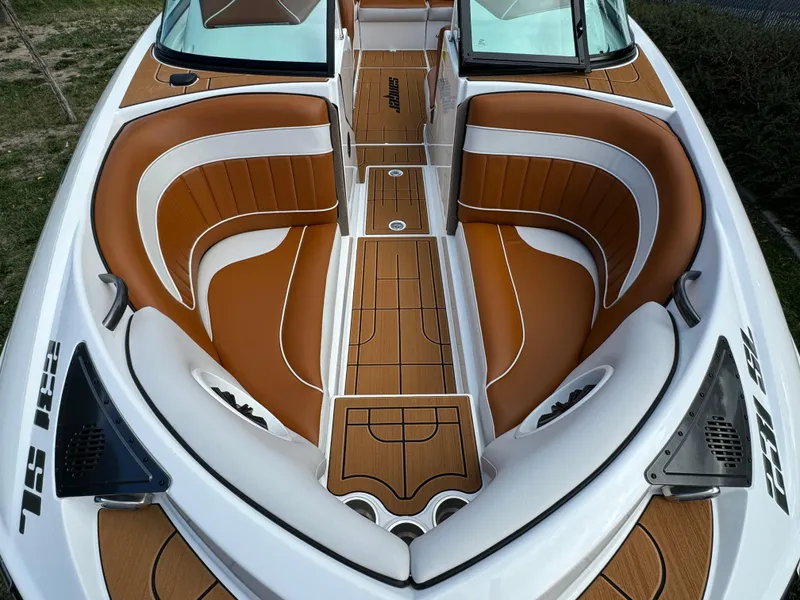Slide: The Image of 2025 Sanger 231SL boat interior with tan and white seating, sleek design. - 14