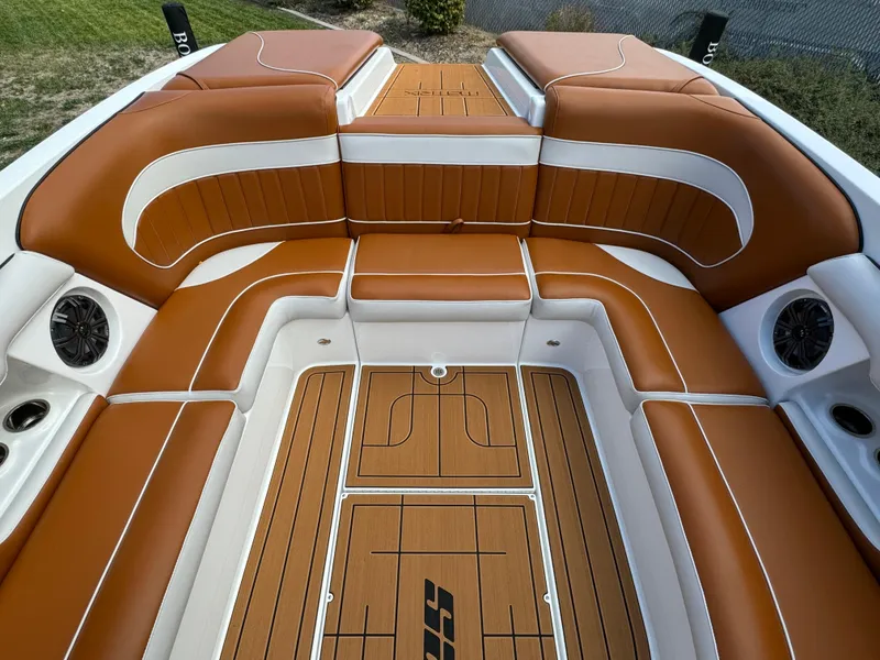 Slide: The Image of Luxurious interior of 2025 Sanger 231SL boat with tan and white seating. - 15