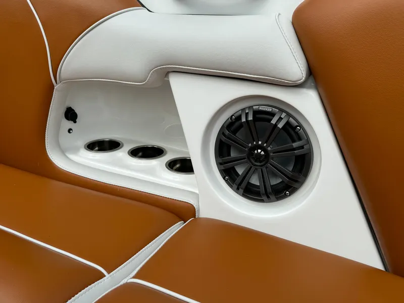Slide: The Image of 2025 Sanger 231SL boat interior with brown leather seats and built-in speaker system. - 16