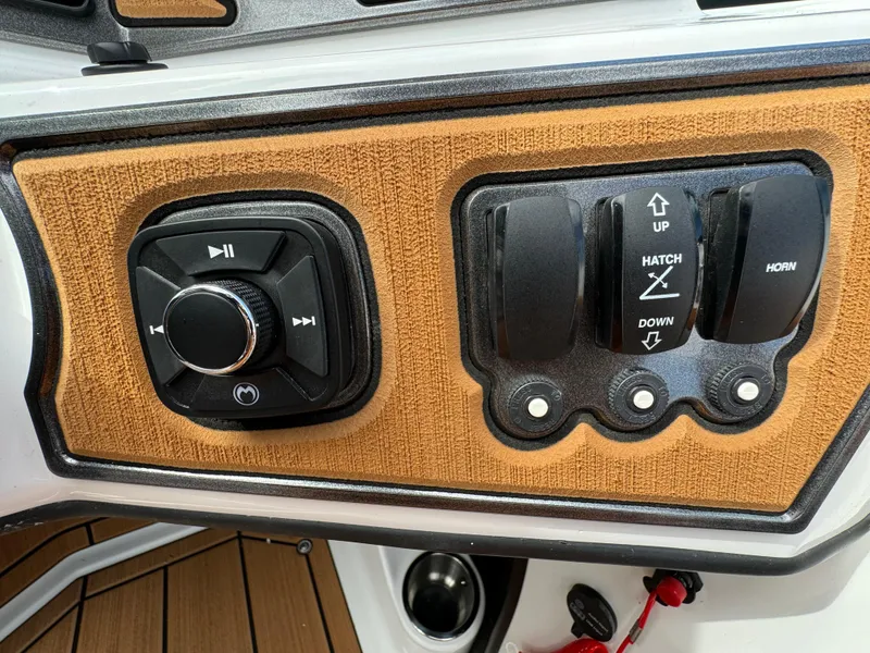 Slide: The Image of Control panel of 2025 Sanger 231SL boat with audio and hatch switches. - 19
