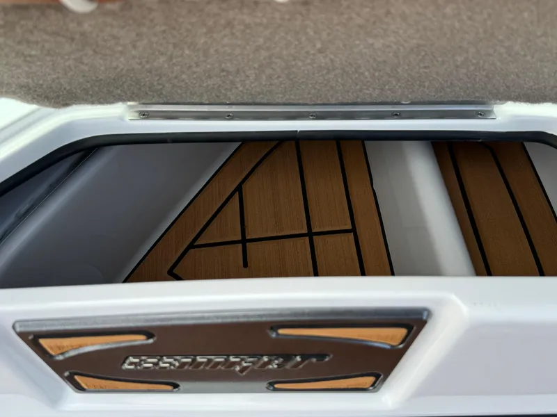 Slide: The Image of 2025 Sanger 231SL boat interior with wood paneling and storage compartment. - 22