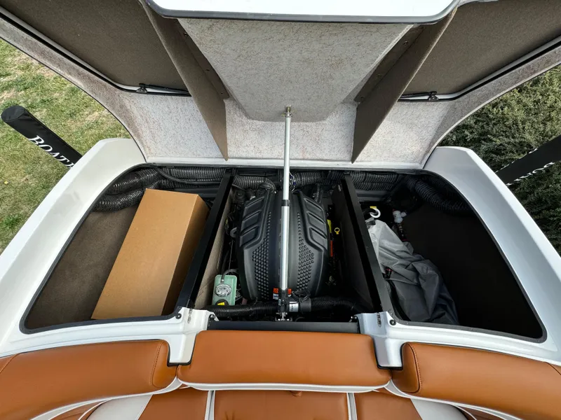 Slide: The Image of Open engine compartment of 2025 Sanger 231SL boat with storage areas. - 29