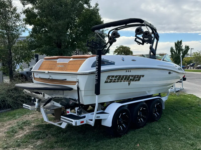 Slide: The Image of 2025 Sanger 231SL boat on trailer, parked outdoors, featuring sleek design and modern equipment. - 3